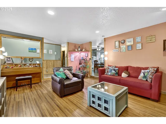 a living room with furniture and a wooden floor