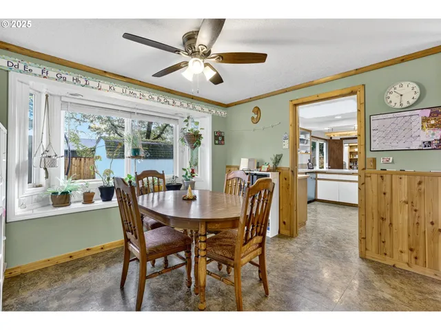 a view of a dining room with furniture and a chandelier