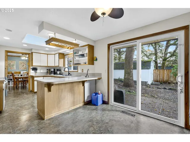 a kitchen with stainless steel appliances kitchen island granite countertop a stove and a cabinets