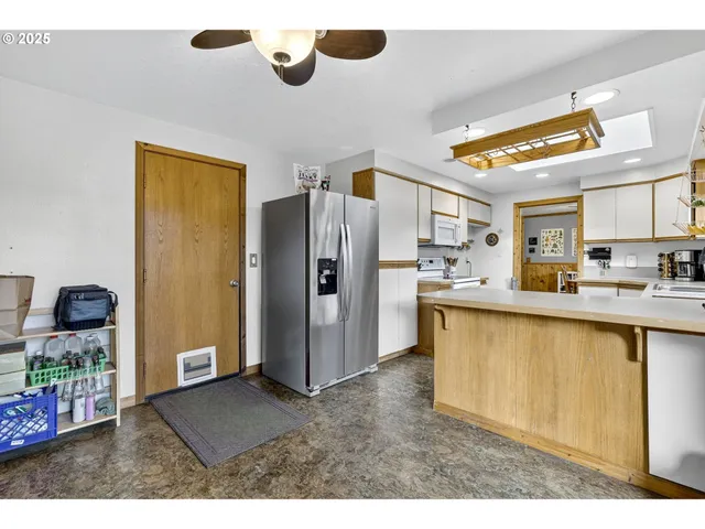 a kitchen with stainless steel appliances granite countertop a refrigerator and a sink