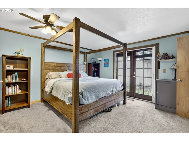 a bed room with a bed and a ceiling fan