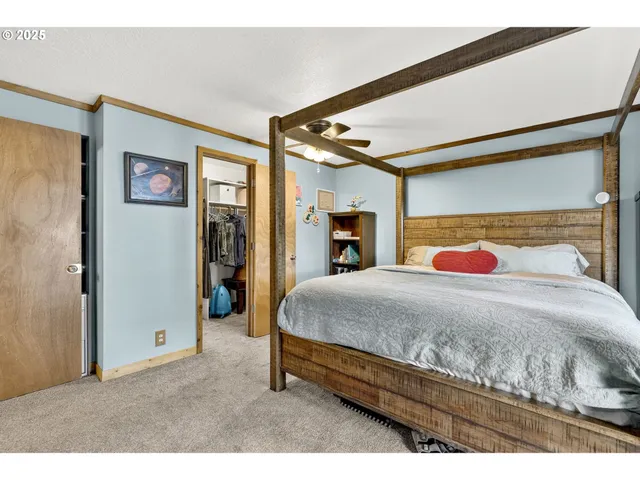 a bedroom with a large bed and a large mirror