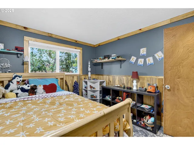 a bedroom with furniture and a large window