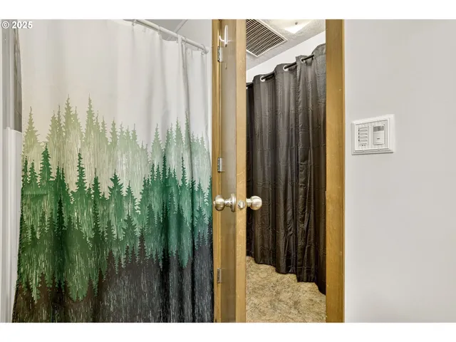 a view of a bathroom with shower and a garden