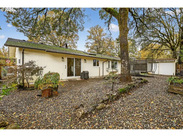 a backyard of a house with table and chairs