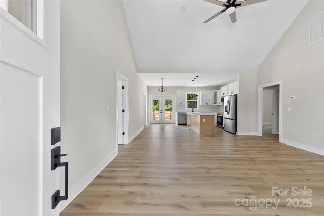 a view of an empty room with wooden floor