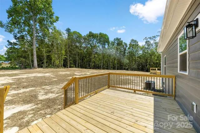 a view of balcony with wooden floor and fence
