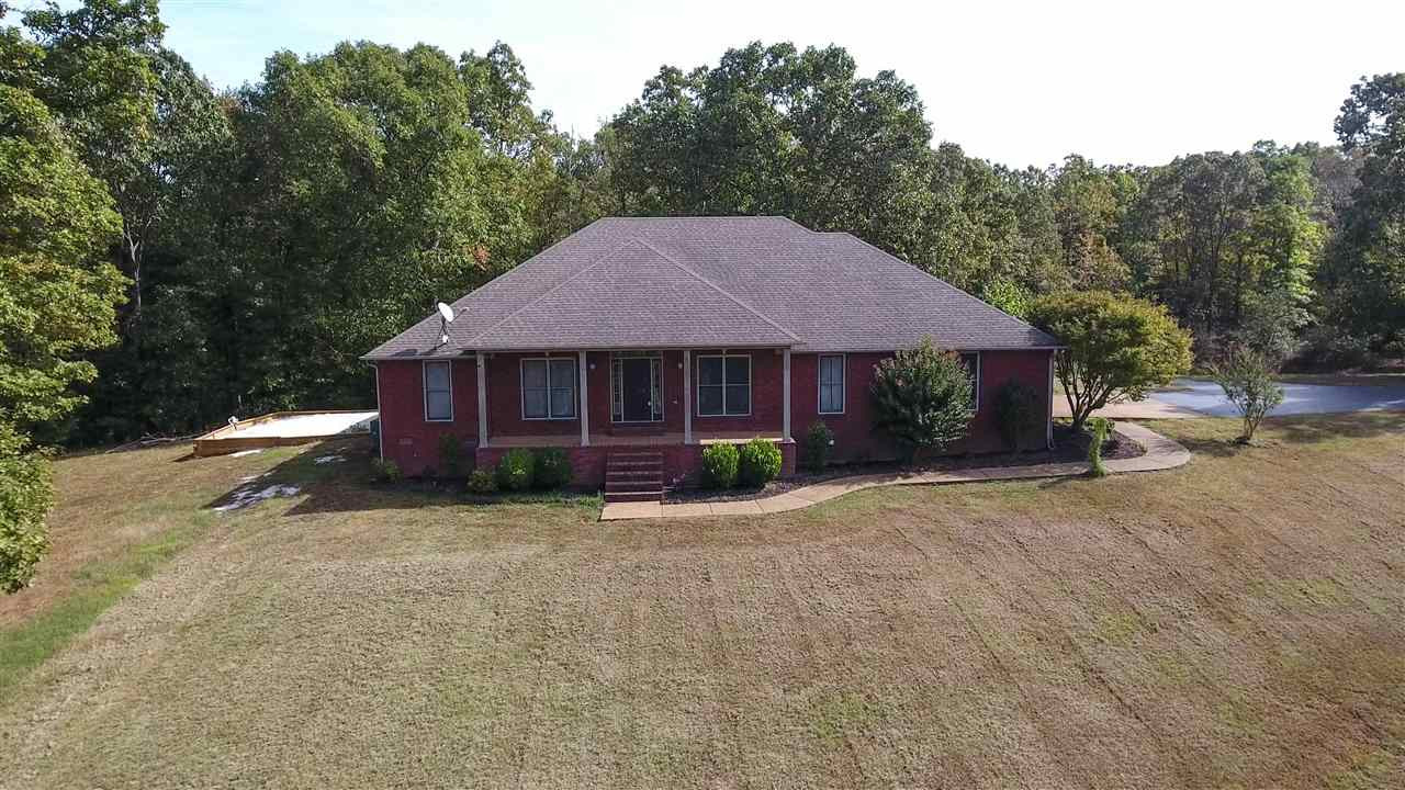 3955 Enville Road Henderson, TN 38340 - Photo 1 of 1 a front view of a house with a yard and trees