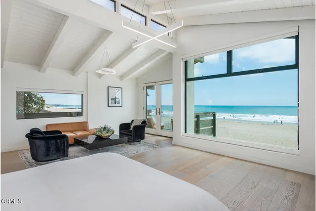 a bedroom with a large bed and a large window