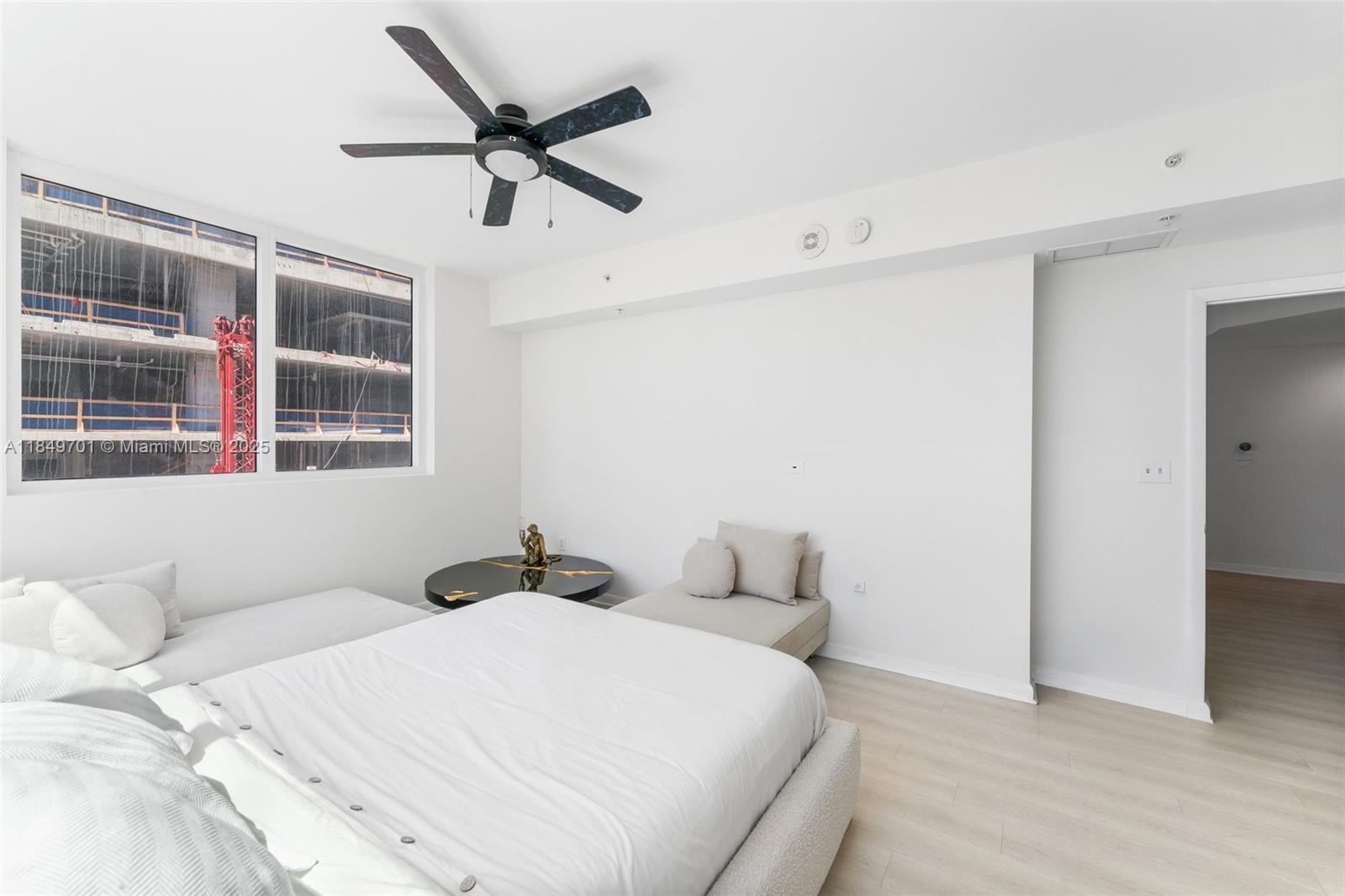 244 Biscayne Boulevard, Unit 1808 Miami, FL 33132 - Photo 11 of 18 a bedroom with a bed and wooden floor