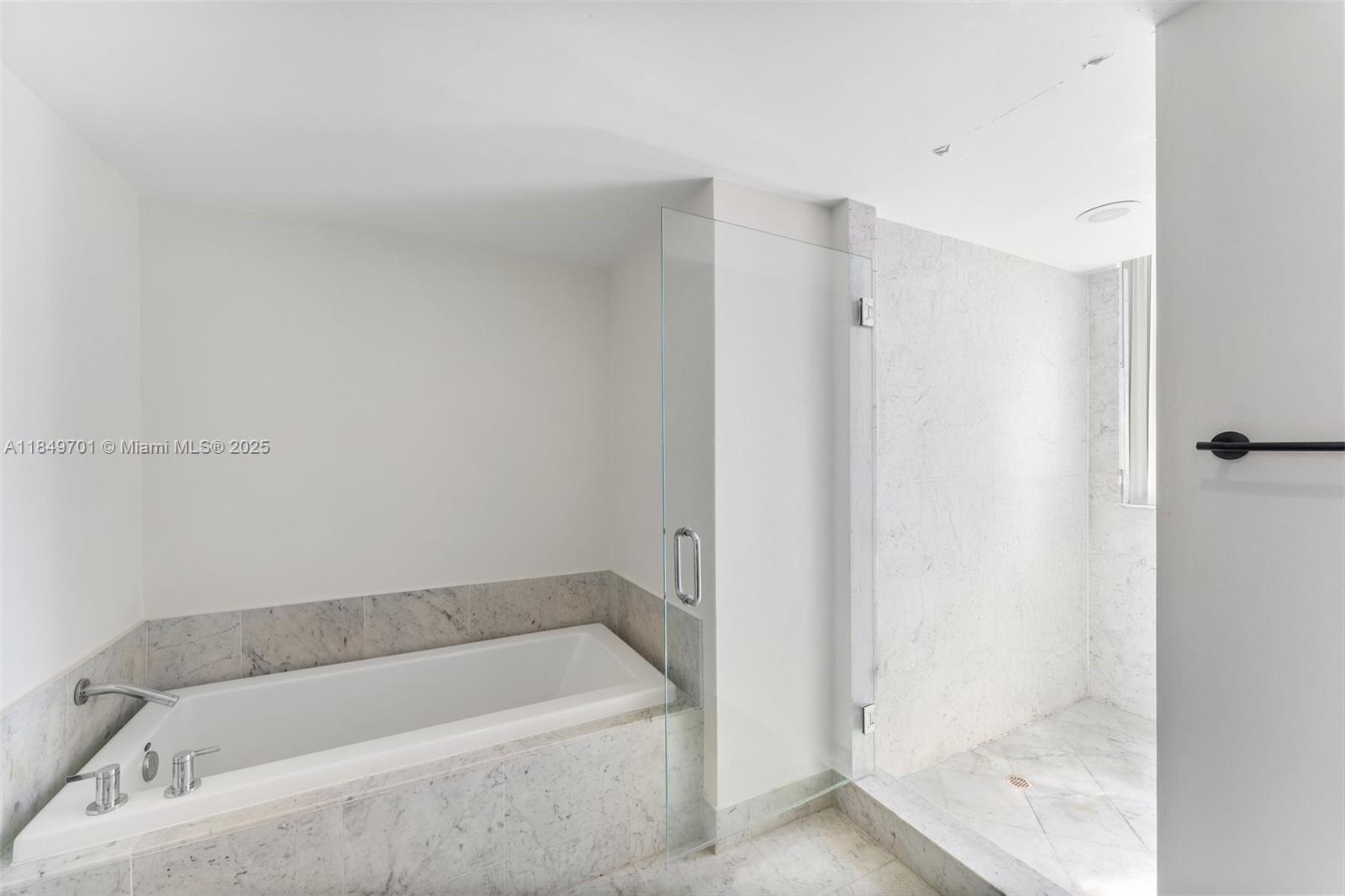 244 Biscayne Boulevard, Unit 1808 Miami, FL 33132 - Photo 14 of 18 a bathroom with a tub and shower
