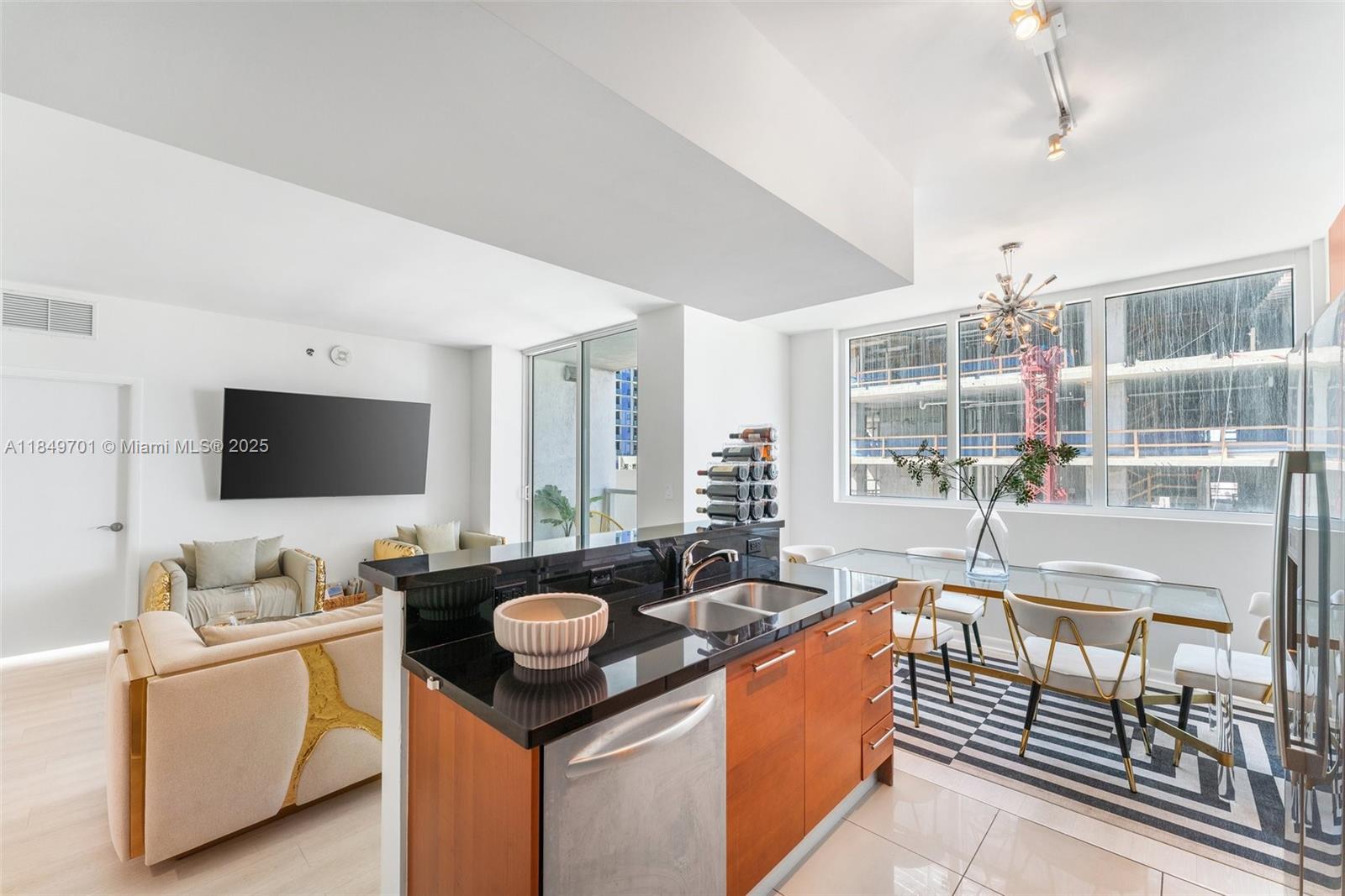 244 Biscayne Boulevard, Unit 1808 Miami, FL 33132 - Photo 5 of 18 a living room with furniture and a flat screen tv