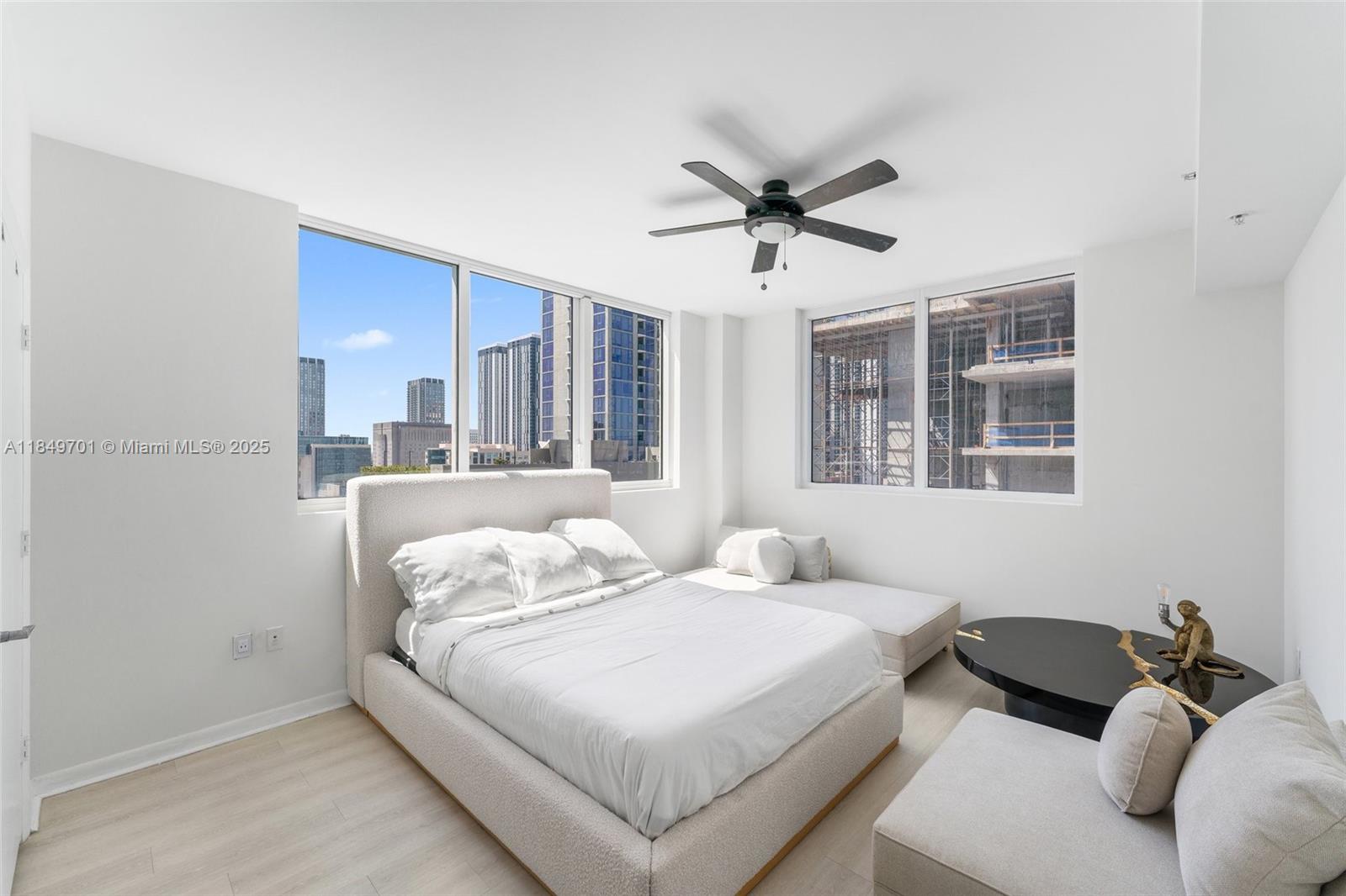 244 Biscayne Boulevard, Unit 1808 Miami, FL 33132 - Photo 10 of 18 a bedroom with a bed and wooden floor