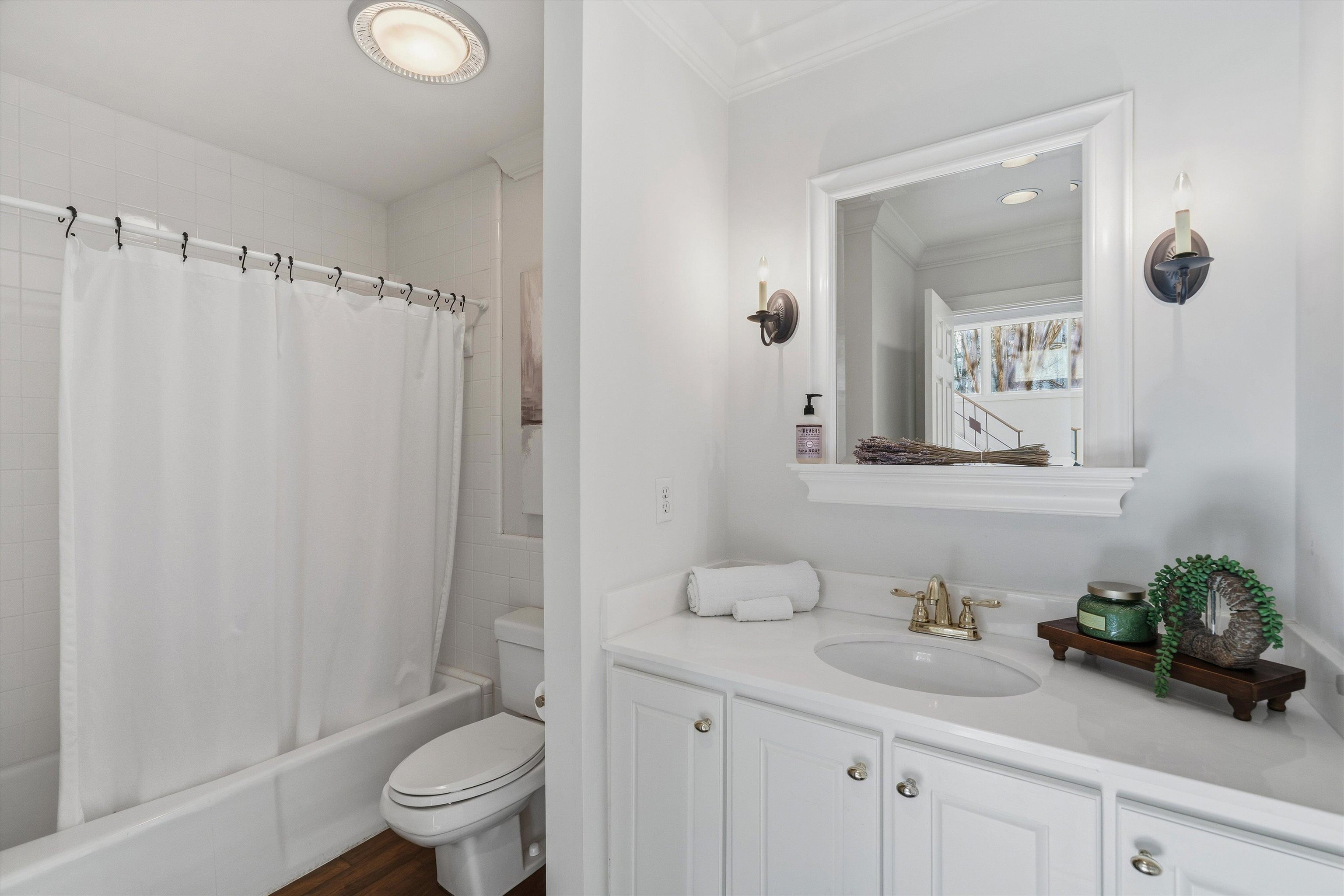 837 Harbor Bend Road Memphis, TN 38103 - Photo 14 of 35 a bathroom with a granite countertop sink a toilet and a mirror