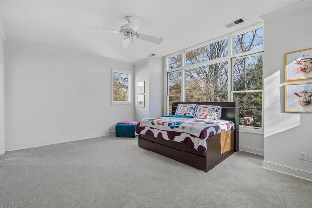 a bedroom with a bed lamp and window