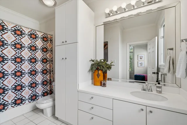 a bathroom with a sink a toilet and a mirror