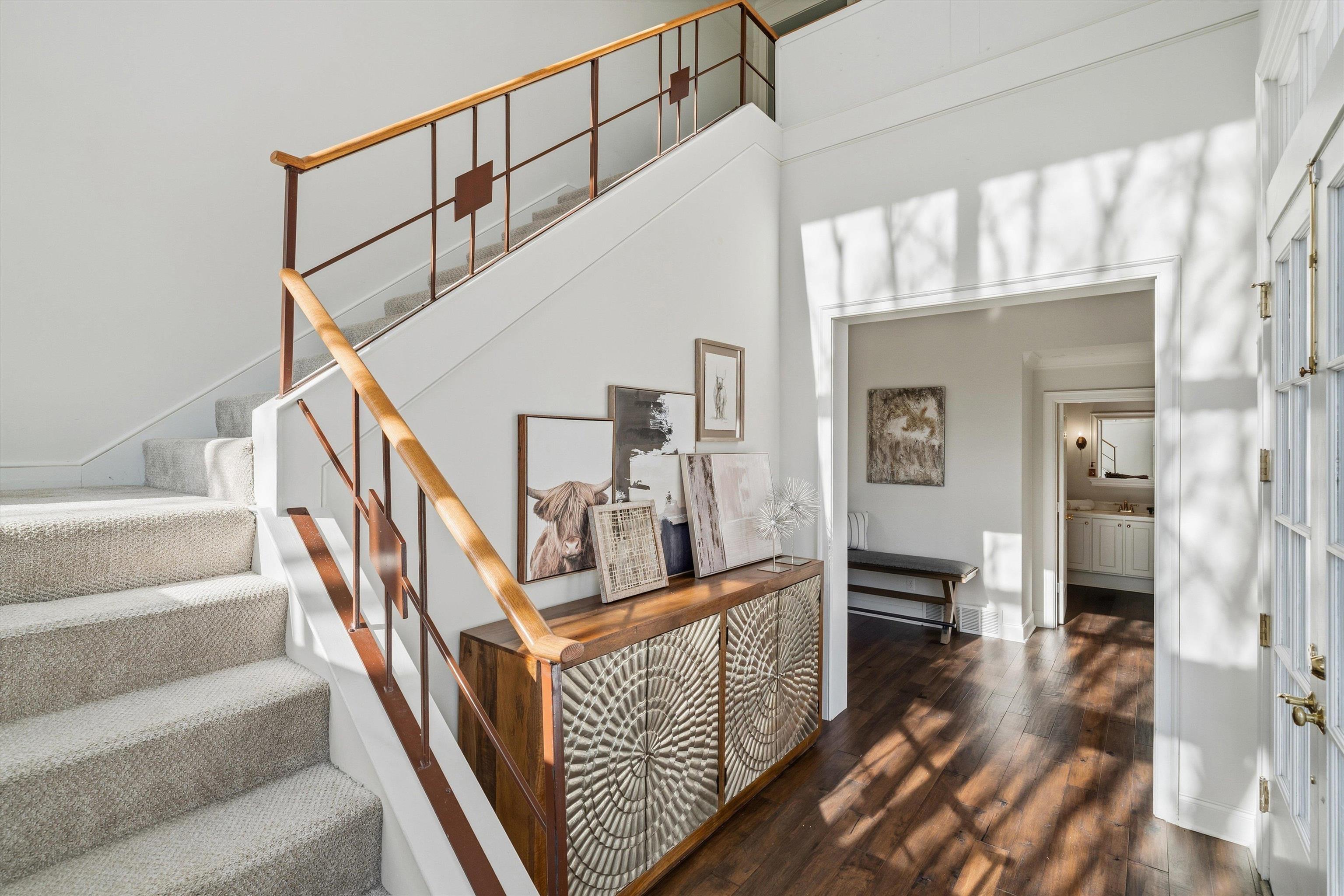 837 Harbor Bend Road Memphis, TN 38103 - Photo 5 of 35 a view of staircase with lots of frames on wall and a table