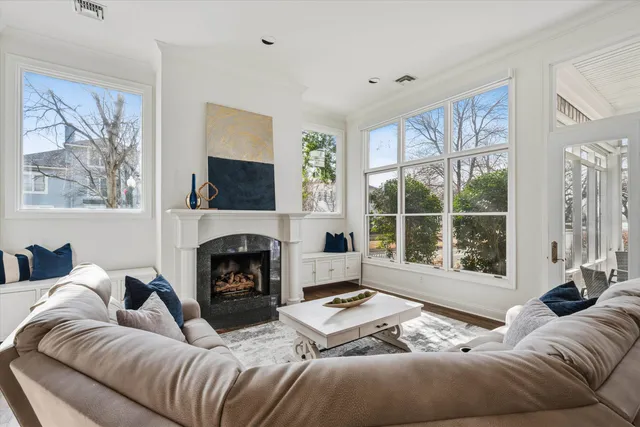 a living room with furniture large window and a fireplace