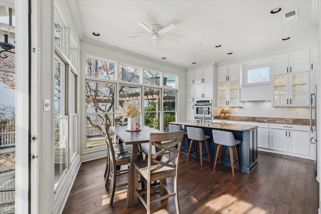 a dining room with furniture and wooden floor