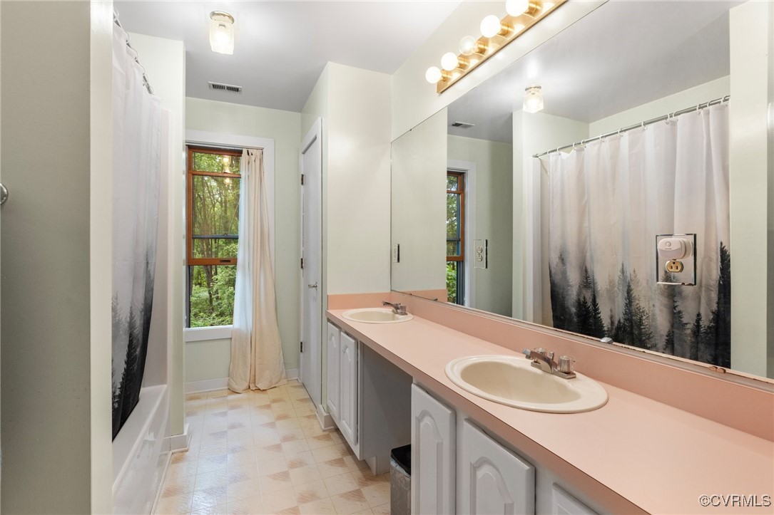 13320 Berkeley Road Orange, VA 22960 - Photo 31 of 46 a bathroom with a double vanity sink and a mirror