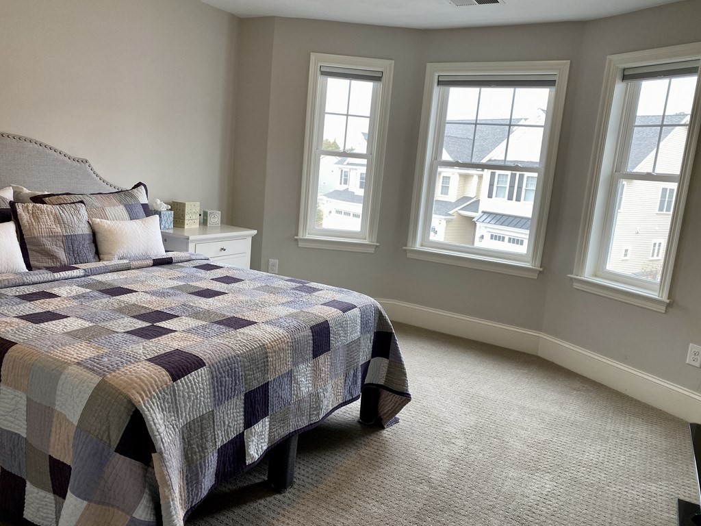 72 Brookview Road, Unit 72 Franklin, MA 02038 - Photo 18 of 29 a large bed sitting in a bedroom next to a window