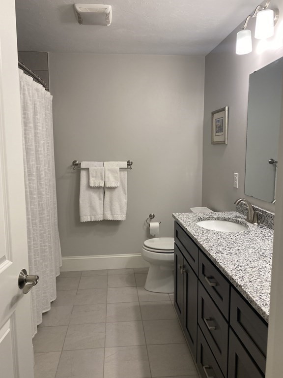 72 Brookview Road, Unit 72 Franklin, MA 02038 - Photo 19 of 29 a bathroom with a granite countertop sink a toilet and shower