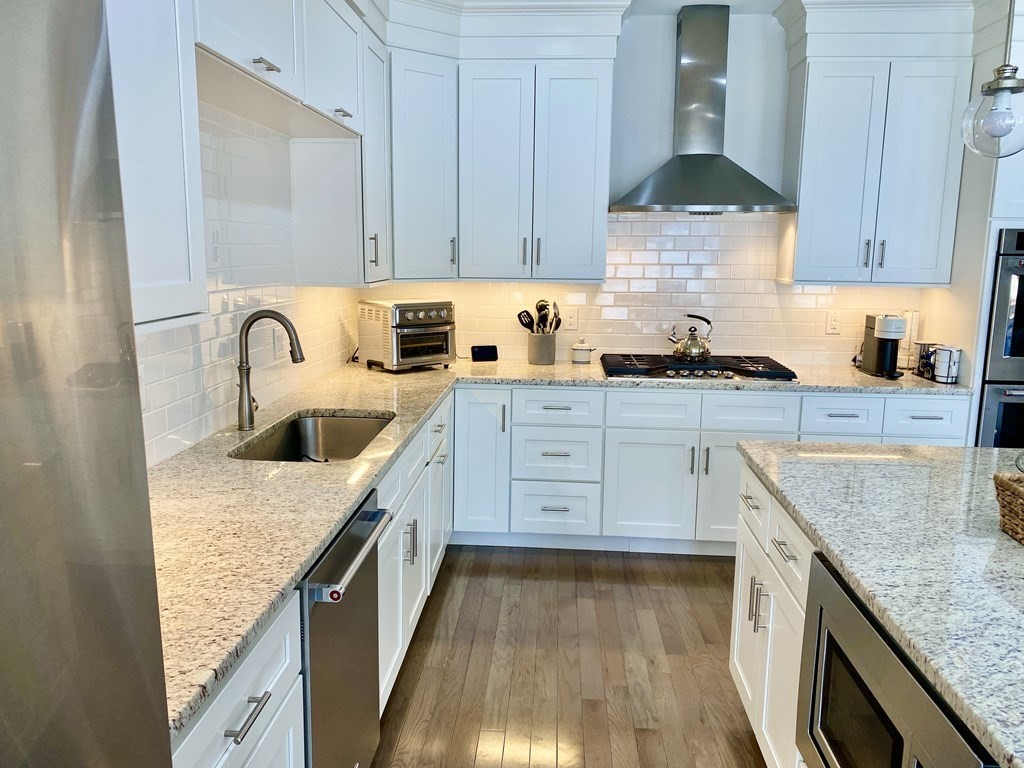 72 Brookview Road, Unit 72 Franklin, MA 02038 - Photo 4 of 29 a kitchen with granite countertop a sink a stove and cabinets
