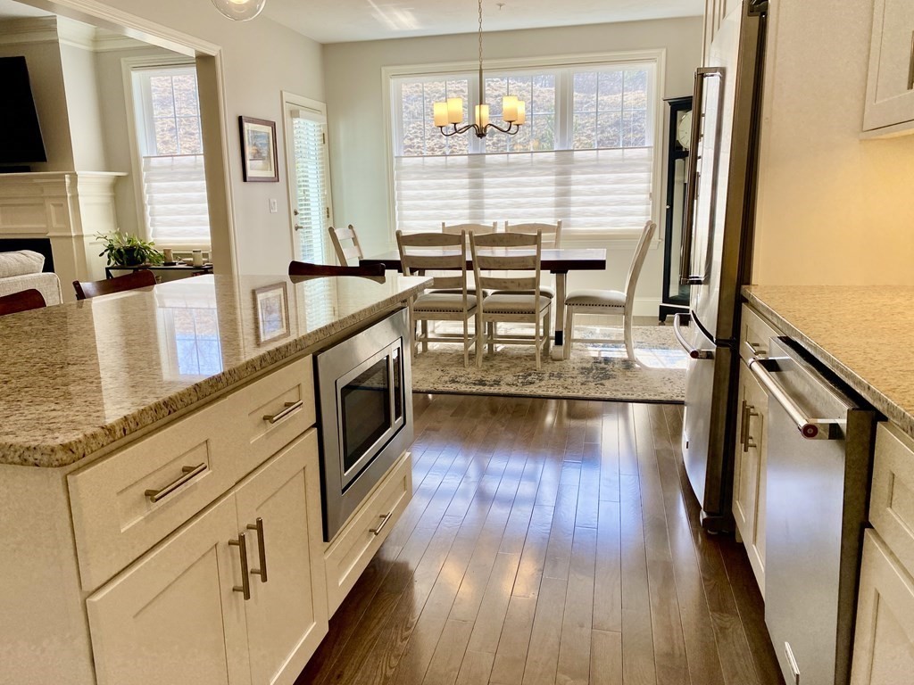72 Brookview Road, Unit 72 Franklin, MA 02038 - Photo 5 of 29 a view of a kitchen with furniture and wooden floor