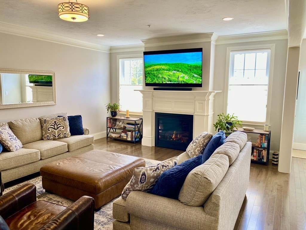 72 Brookview Road, Unit 72 Franklin, MA 02038 - Photo 9 of 29 a living room with furniture and a fireplace