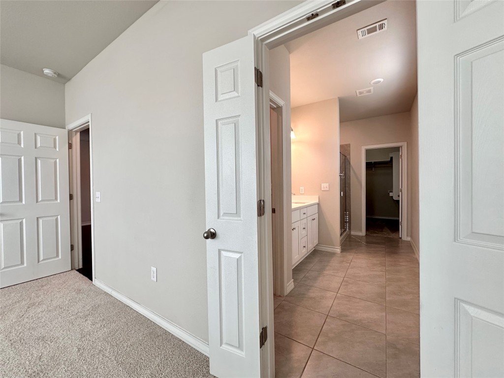 11604 Roxburgh Pass Manor, TX 78653 - Photo 15 of 40 a view of a hallway with closet and bathroom