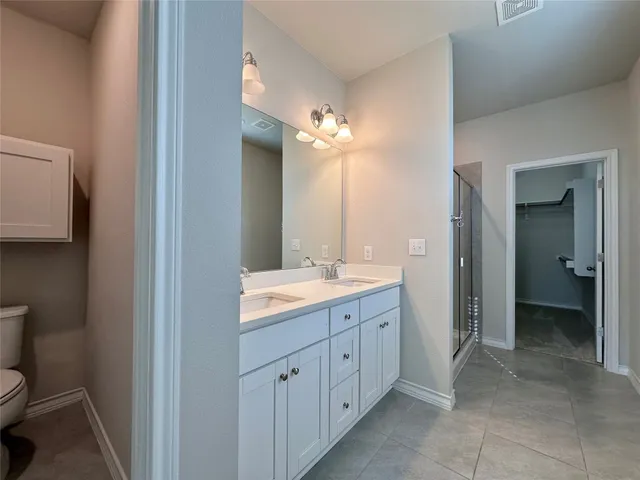 a view of a hallway with closet and bathroom