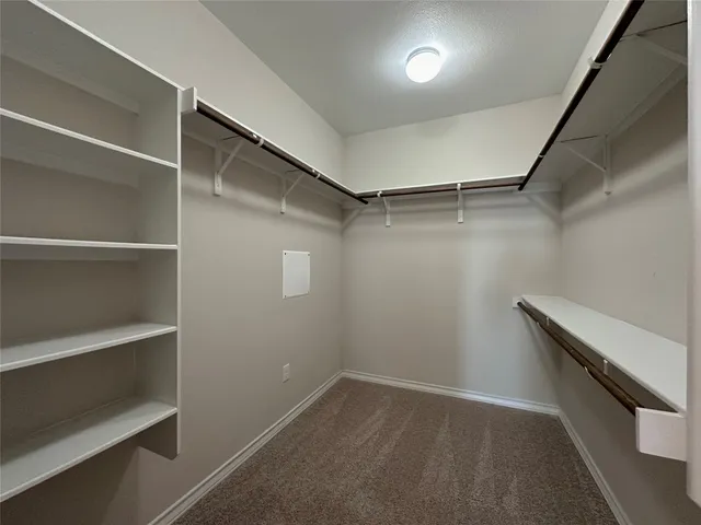 a spacious bathroom with a double vanity sink toilet and a mirror