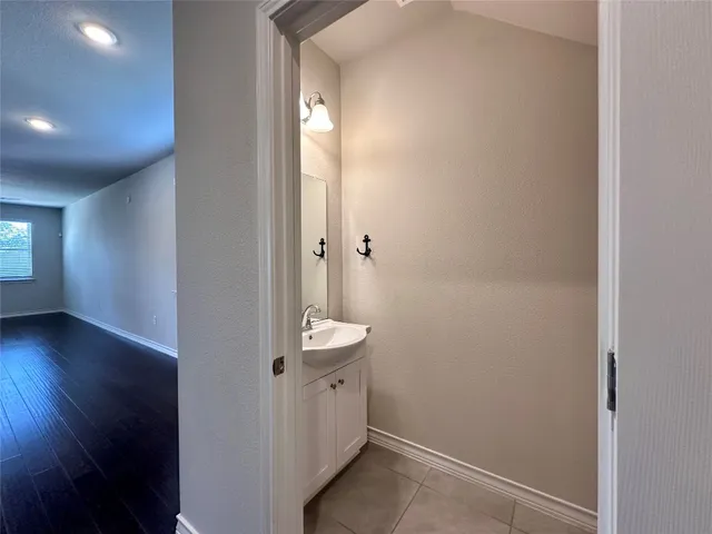 a view of kitchen with stainless steel appliances wooden floor large window and wooden floor