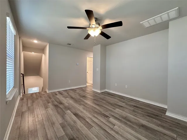 a view of room with a ceiling fan and window