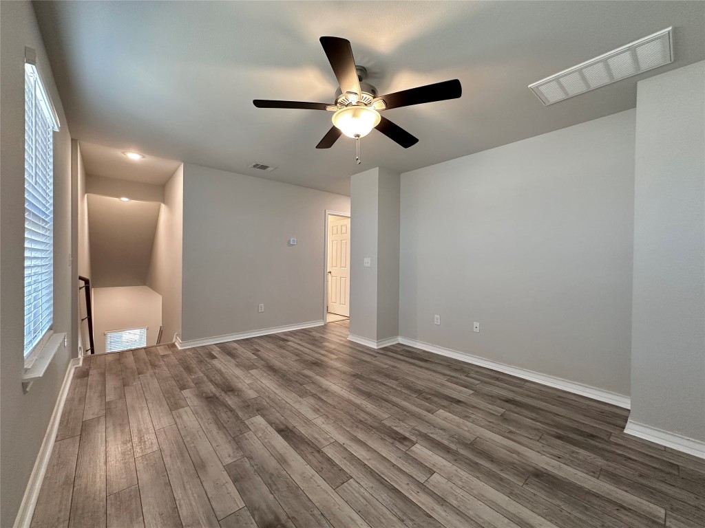 11604 Roxburgh Pass Manor, TX 78653 - Photo 26 of 40 a view of an empty room and wooden floor