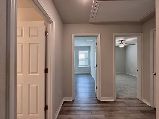 a view of an empty room and wooden floor