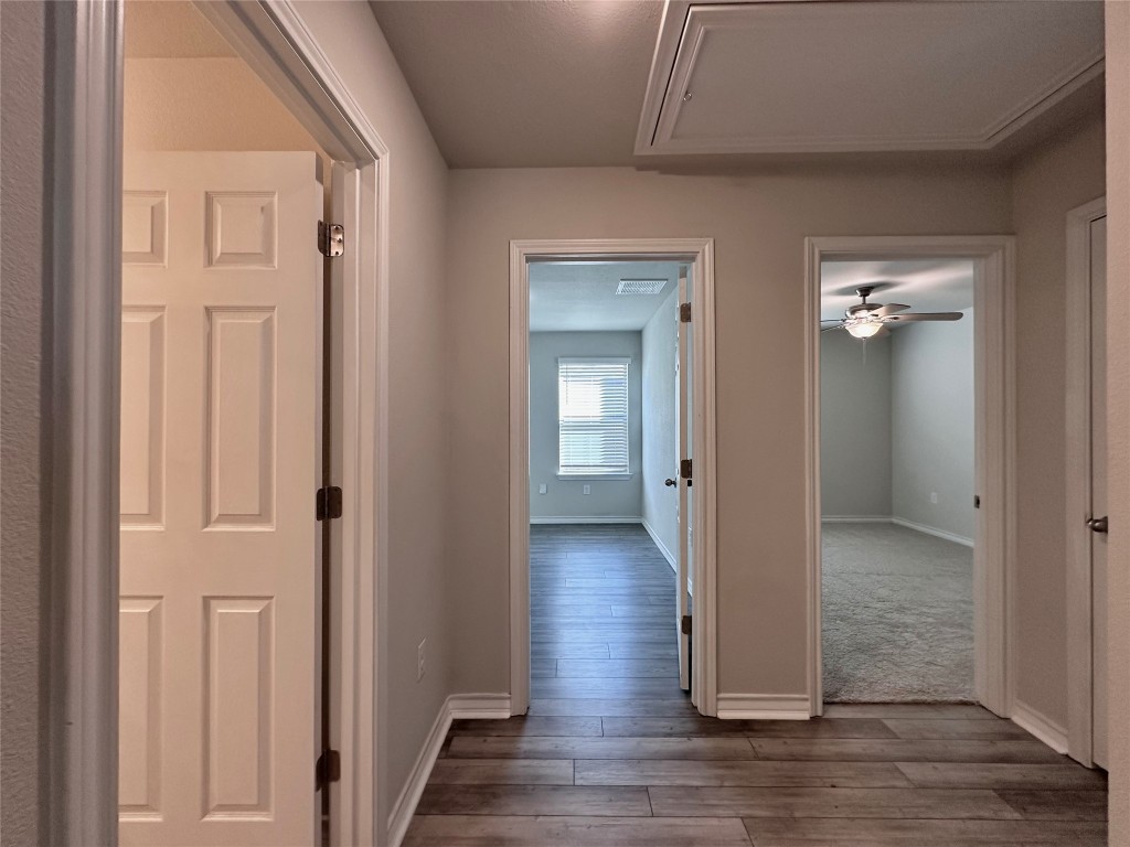 11604 Roxburgh Pass Manor, TX 78653 - Photo 27 of 40 a view of a hallway with wooden floor