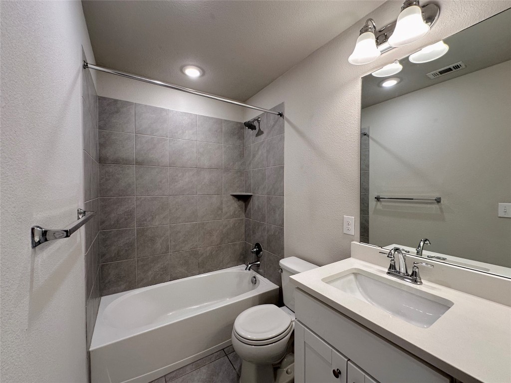 11604 Roxburgh Pass Manor, TX 78653 - Photo 28 of 40 a bathroom with a sink a toilet and a mirror