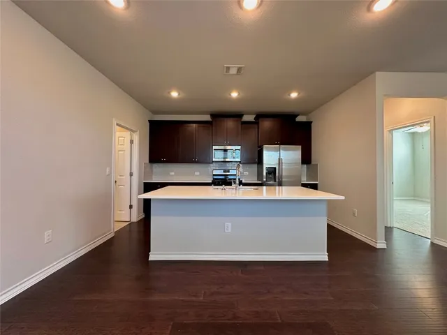 a view of a kitchen with a sink and a large window