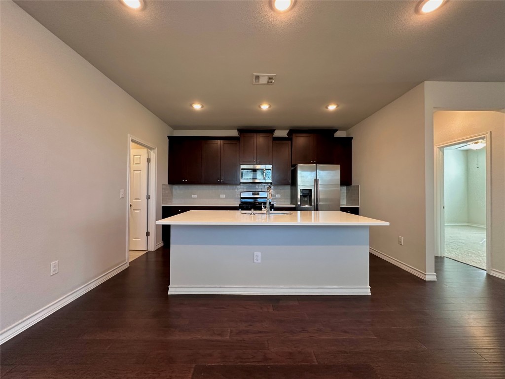 11604 Roxburgh Pass Manor, TX 78653 - Photo 6 of 40 a view of kitchen with stainless steel appliances refrigerator sink and cabinets