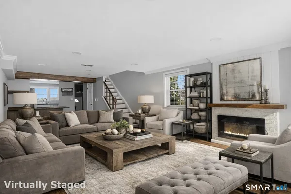 a living room with furniture and a fireplace