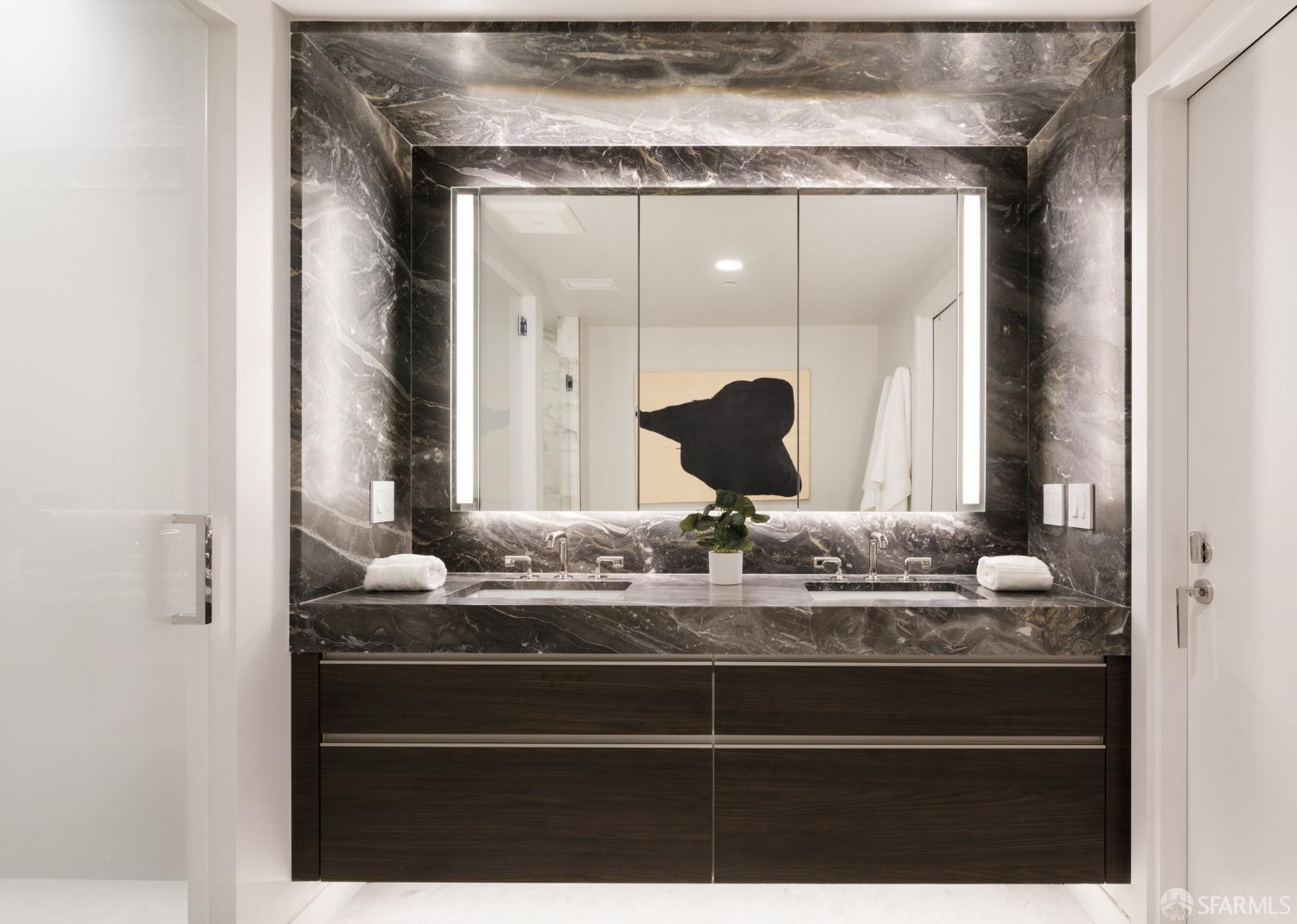 2525 Van Ness Avenue, Unit 601 San Francisco, CA 94109 - Photo 18 of 48 a bathroom with a granite countertop sink a mirror and shower