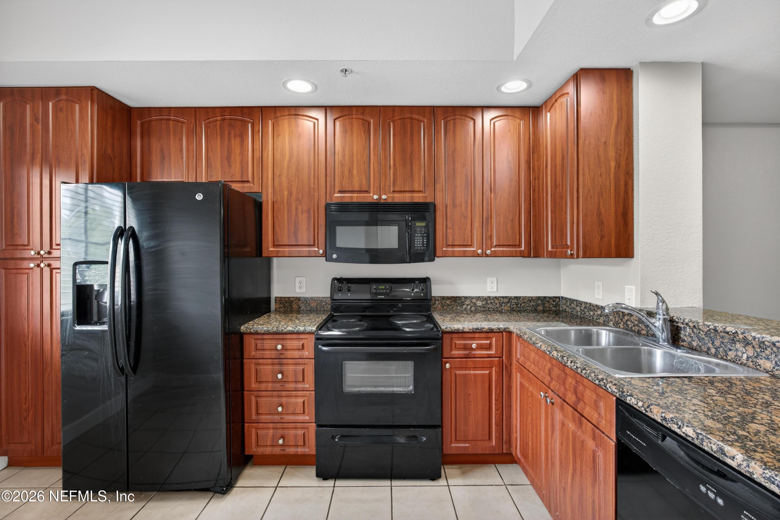 9745 Touchton Road, Unit 1224 Jacksonville, FL 32246 - Photo 4 of 22 a kitchen with stainless steel appliances granite countertop a refrigerator stove and sink