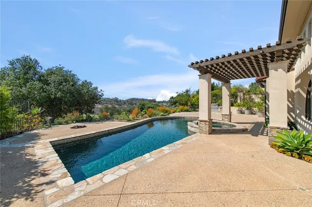a view of swimming pool with outdoor seating and plants