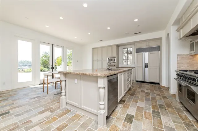 a large white kitchen with a large window