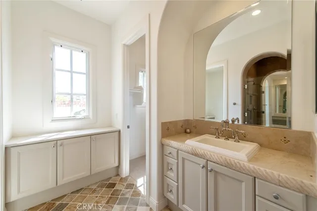 a en suite bathroom with a sink and a window