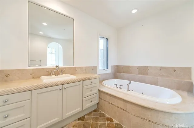 a bathroom with a bathtub and a sink