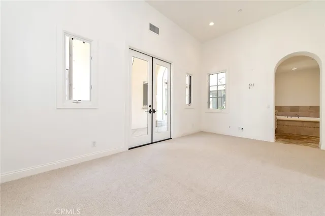 an empty room with windows and closet