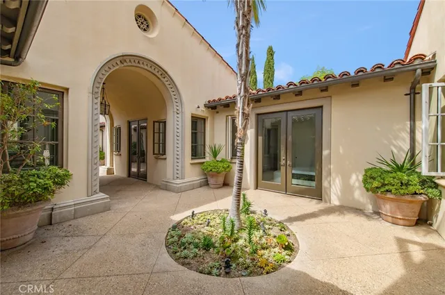 a view of a house with potted plants