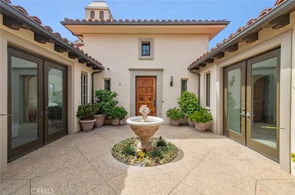 a view of a house with potted plants